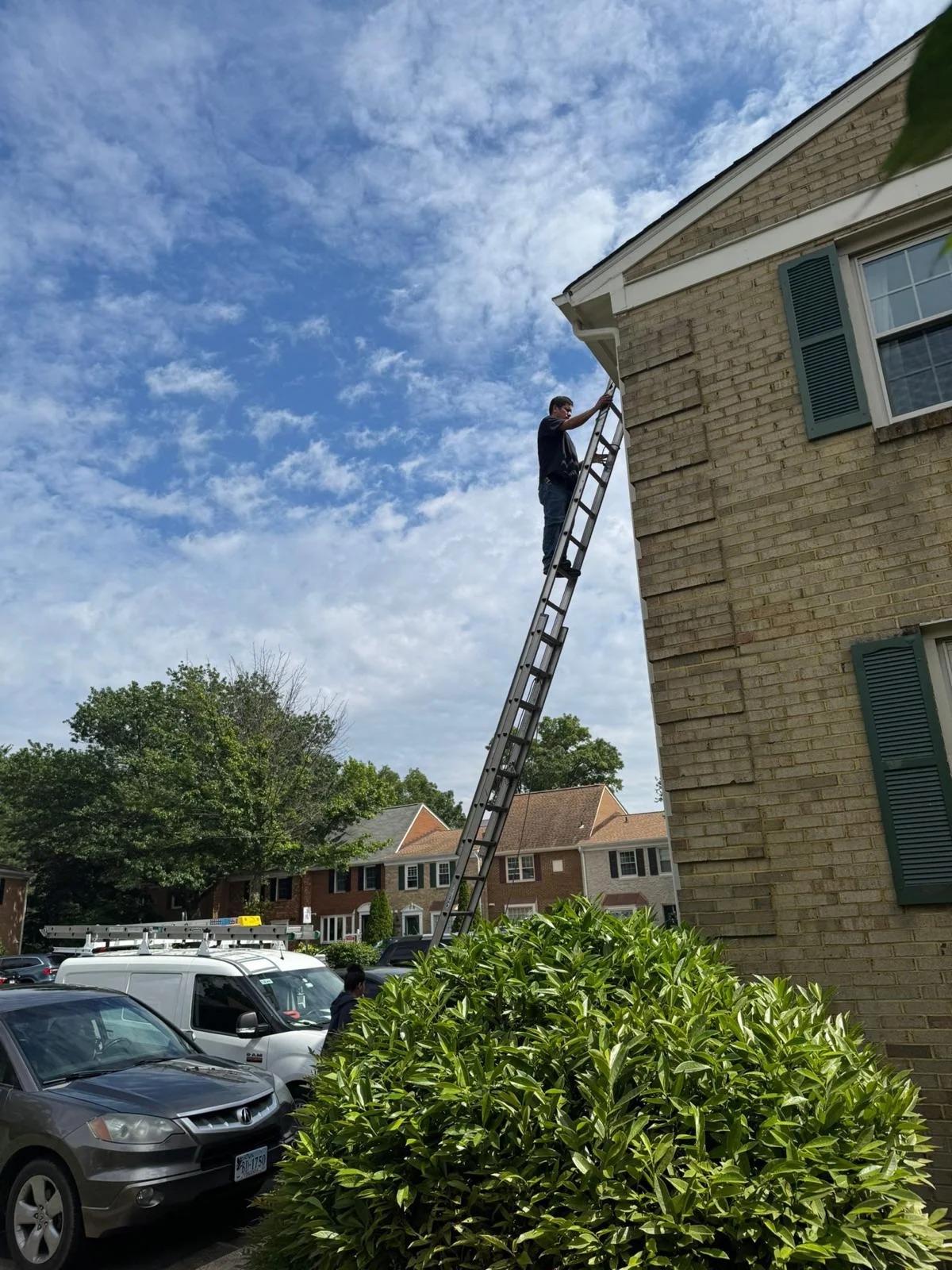 United Chimney Sweep & Repair technician setting up a ladder on-site at a customer's home